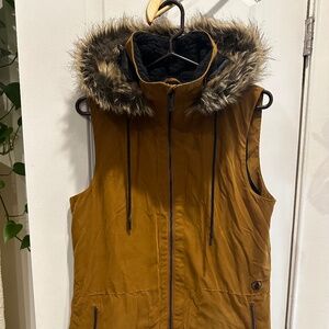 Volcom deep mustard colored vest with a fur lined hood